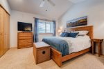 Master bedroom with king bed, TV, ceiling fan